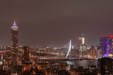 Rotterdam skyline with Erasmus bridge at twilight as seen from the Euromast tower, The Netherlands. Night urban landscape with tall buildings of a large European port city
