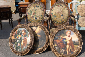 Antique Wooden Stuffed - Chairs and Antique Paintings Leaning Outside on the Street