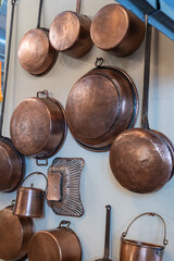 Copper Pots and Pans and other Kitchen Utensils in an Antique Kitchen.