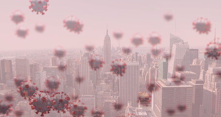Image of covid 19 cells floating over cityscape on pink background