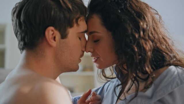 Sexy family embracing home feeling desire close up. Passionate couple intimacy