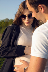 Closeup of a couple of beautiful lovers spend time outdoors on the summer day. 