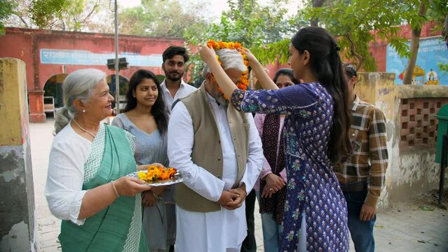 Political party supporters welcoming the political party leader with flower garland - public servant  the Indian government  lok sabha member. A politician being congratulated for the win in the el...
