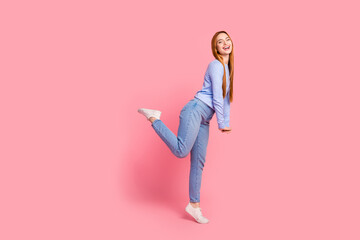 Full size photo of lovely adorable woman dressed blue shirt jeans standing on one leg having fun...
