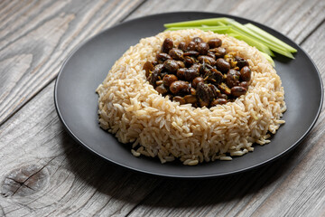 Black soybeans curry served with brown basmati rice and celery stalks. 