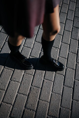 Woman legs wearing penny loafers and black socks