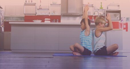 Asian and caucasian brothers performing yoga in the kitchen at home