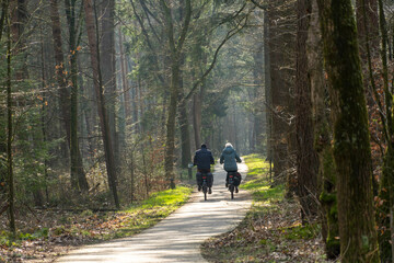 Senior couple bicycling in the forest of the city of Ermelo.
