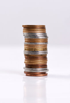 Money, coins stack and change on table top for finance, investment and cash tips for budgeting progress. Savings pile, counting rands or bank balance for economic recession, earnings or banking funds