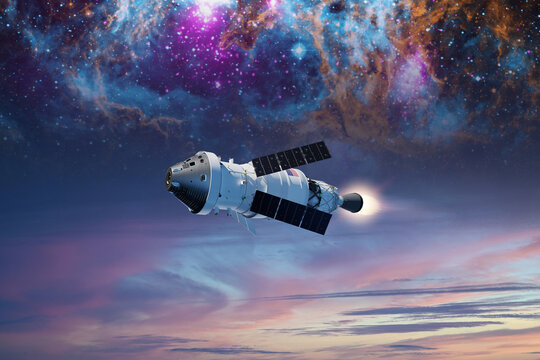 Sci-fi concept with Orion spacecraft in outer space on nebula background. Elements of this image furnished by NASA.