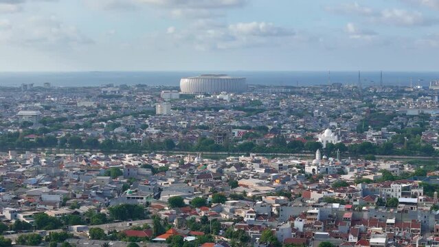 aerial view of the Jakarta International Stadium surrounded by residential homes in Indonesia
