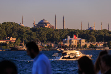 Evening view of the city, Sunset sky. Old Mosques with minarets. Public place in Istanbul, Turkey. 