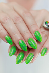 Female hand with long nails and neon green manicure