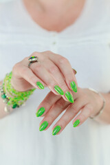 Female hand with long nails and neon green manicure