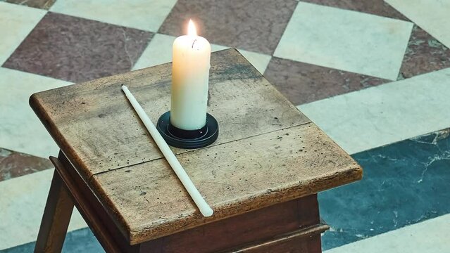 Candle on backless stool