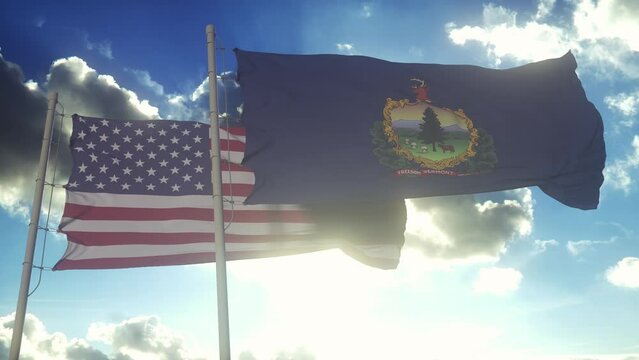 The Vermont state flags waving along with the national flag of the United States of America. In the background there is a clear sky