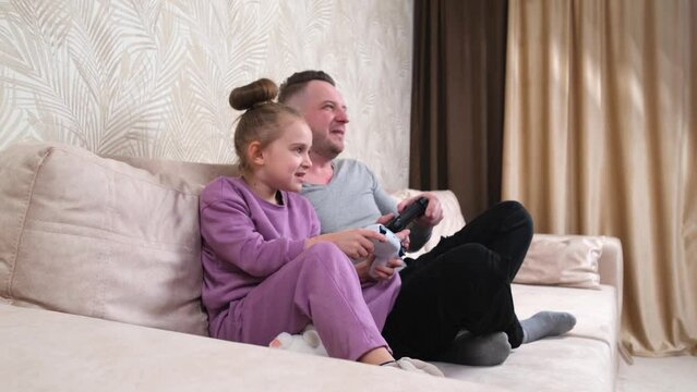 Family time at home father with daughter. Weekend activities, free time, home entertainment and video games concept.