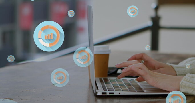 Image of graph icons over cropped hands of caucasian woman working on laptop in cafes - Powered by Adobe