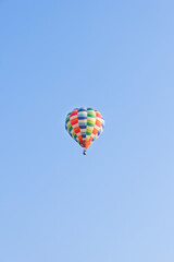 Hot air balloons landing in a mountain flight over field and forest,colorful Hot air balloons flying over the valley with blue sky,Tourism concept.