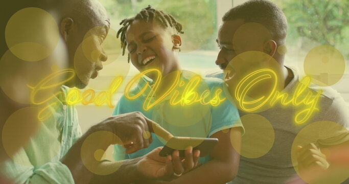 Image of good vibes only text over african american family using smartphone