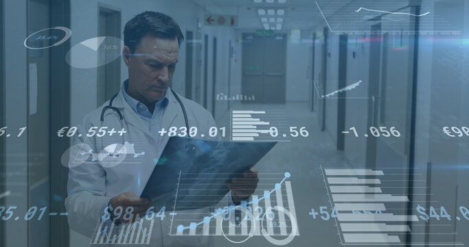 Image of financial data processing over caucasian male doctor with x ray scan