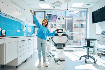 Happy girl in a modern dental office