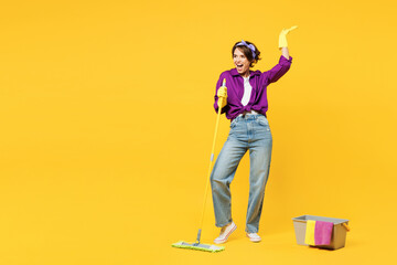 Full body young fun woman wear purple shirt casual clothes do housework tidy up hold mop bucket...