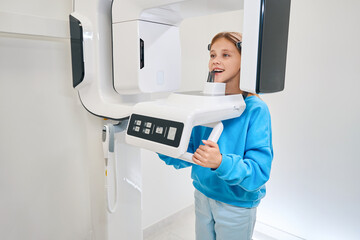 Young female patient undergoing a dental x-ray procedure