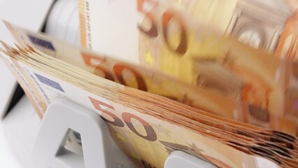 Euro banknotes. Bank automatic equipment money counting machine cash. Close-up of 50 euro banknotes counted macro top view slow motion. European union currency. Inflation,  economy, investment, income