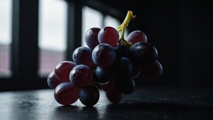 A close-up of a ripe red grape cluster isolated on a black background