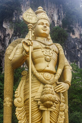 Lord Murugan with Vel at Batu Caves, Murugan Temple. Big golden Murugan statue at Batu Caves, the...