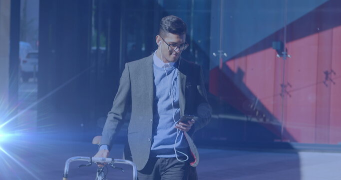 Image of light spots over biracial businessman using smartphone - Powered by Adobe