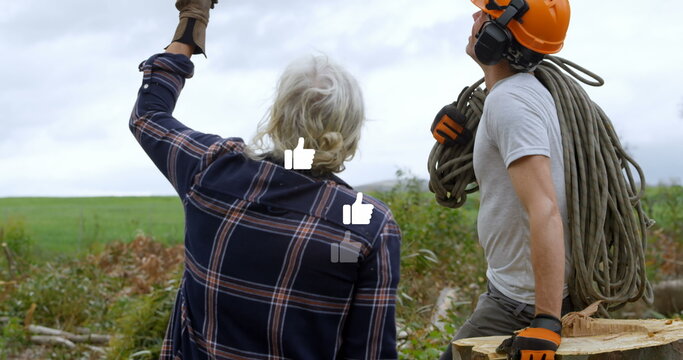 Image of falling icons over two lumberjacks - Powered by Adobe