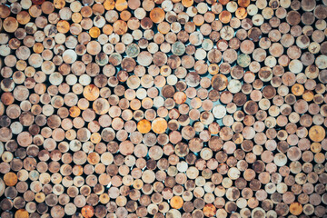 Background of wooden round logs neatly folded.