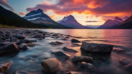 Tranquil mountain sunset with colorful sky reflecting on serene lake, capturing vibrant evening hues