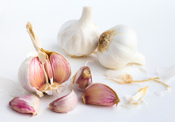 Garlic heads and cloves on white background