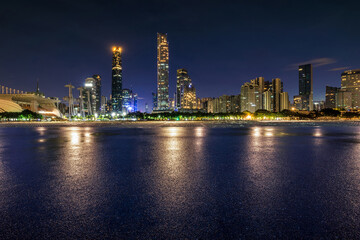 Asphalt road square and city skyline with modern buildings at night in Guangzhou