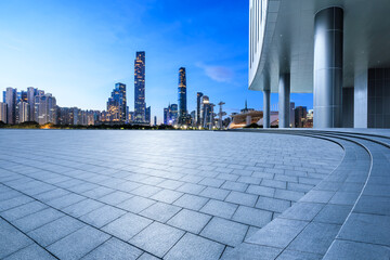 Empty square floors and city skyline with modern buildings at night in Guangzhou
