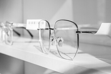 exhibitor of glasses consisting of shelves of fashionable glasses shown on a wall at the optical...