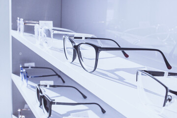 exhibitor of glasses consisting of shelves of fashionable glasses shown on a wall at the optical shop