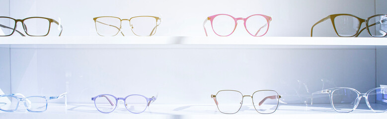 exhibitor of glasses consisting of shelves of fashionable glasses shown on a wall at the optical...