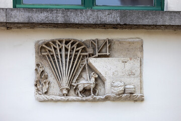 Relief of facade of tenement house next to Zuivelbrug bridge by Lys river (Leie), Ghent, Belgium