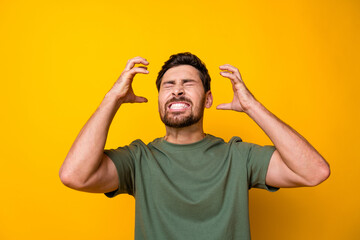 Photo of abusive angry guy dressed green t-shirt closed eyes screaming rising arms hands isolated...