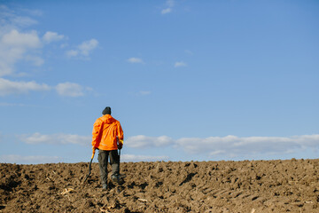 Man with a metal detector in the field. Search for treasures.