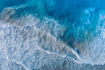 Ocean surf. Waves roll onto the shore. View from above. Natural abstract background - 758066658