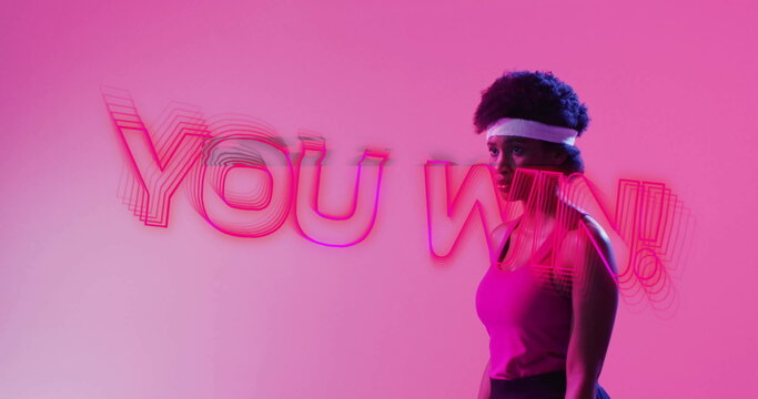 Image of you win text, neon pattern african american female tennis player