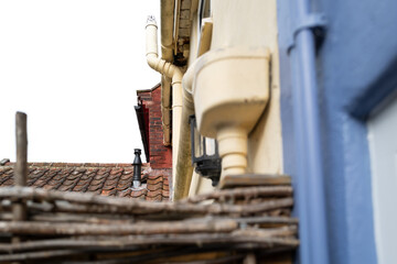 Shallow focus of a newly installed central heating flue pipe seen rising from a distant terraced...