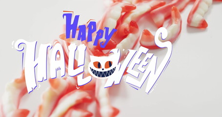 Image of happy halloween text with cat over teeth sweets
