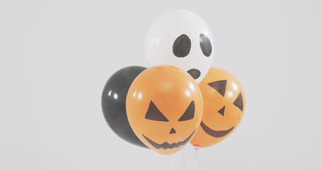 Image of happy halloween text over neon witch and orange and black balloons