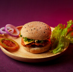 Burger served on a wooden plate with lettuce, onion, and tomato. social media post, food photography, fine dining, purple background, restaurant menu, fast food, junk food, street food, delicious